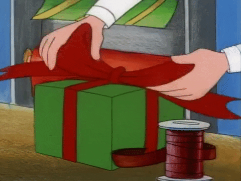 hey-arnold-tightening-gift-bow-on-red-and-green-gift
